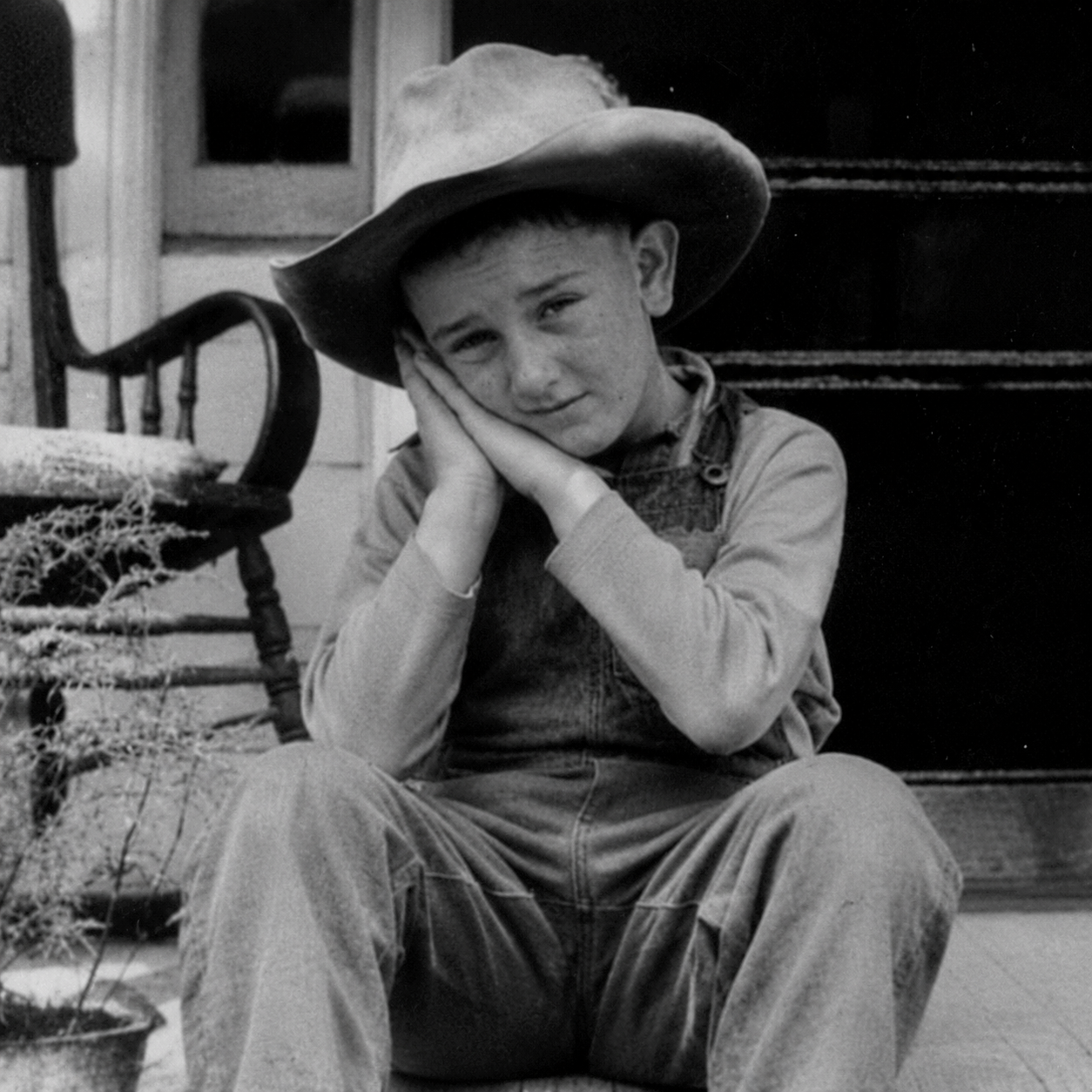 Lyndon Johnson do sleep motion by using hands as pillow with eyes open while looking at the viewer  straight ahead
