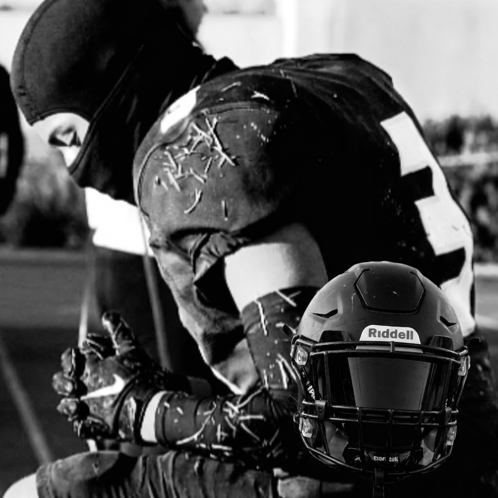 Can you add a Speedflex Football Helmet with a Black visor  in one of my hands facing down while keeping my other hand on my lap  me in the same position