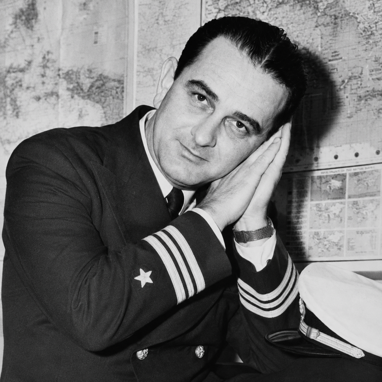 Lyndon Johnson do sleep motion by using hands as pillow with eyes open while looking at the viewer  straight ahead