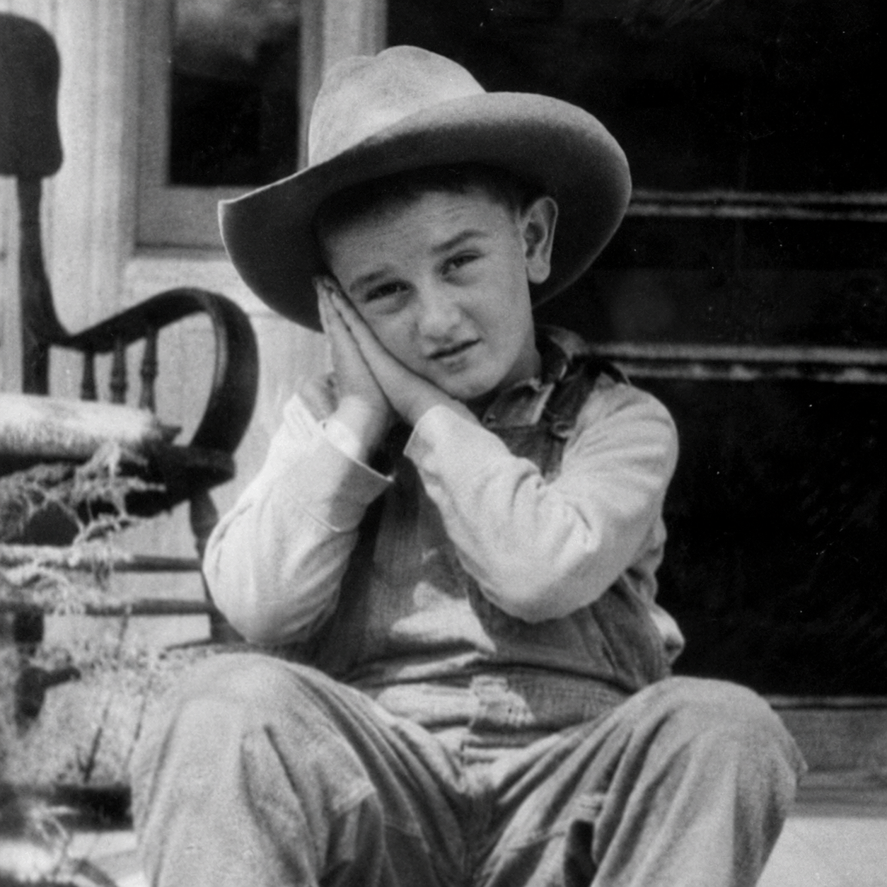 Lyndon b johnson do sleep motion by using hands as pillow with eyes open while looking at the viewer